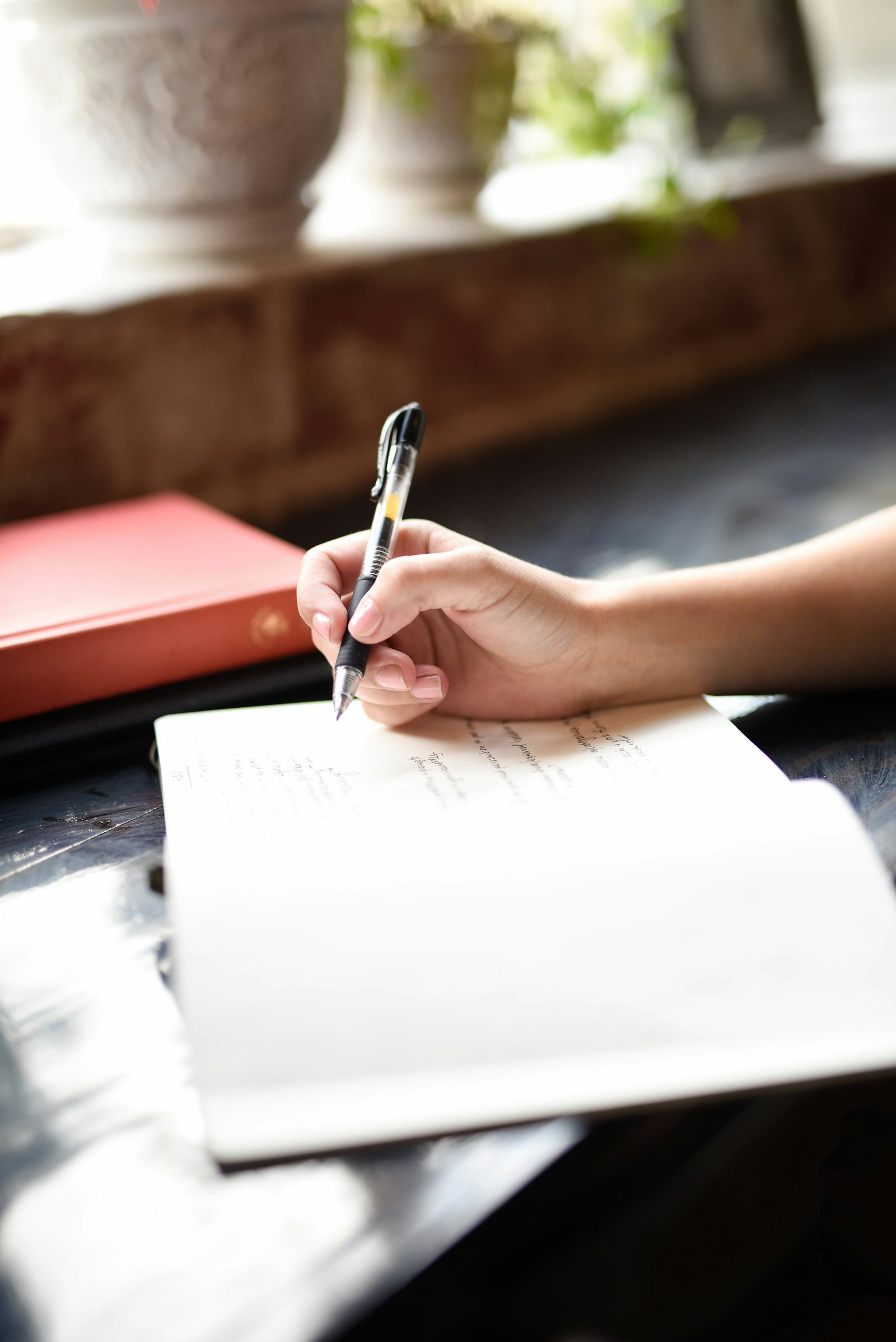 Open notebook and pen on a desk beside a laptop, ready for note-taking