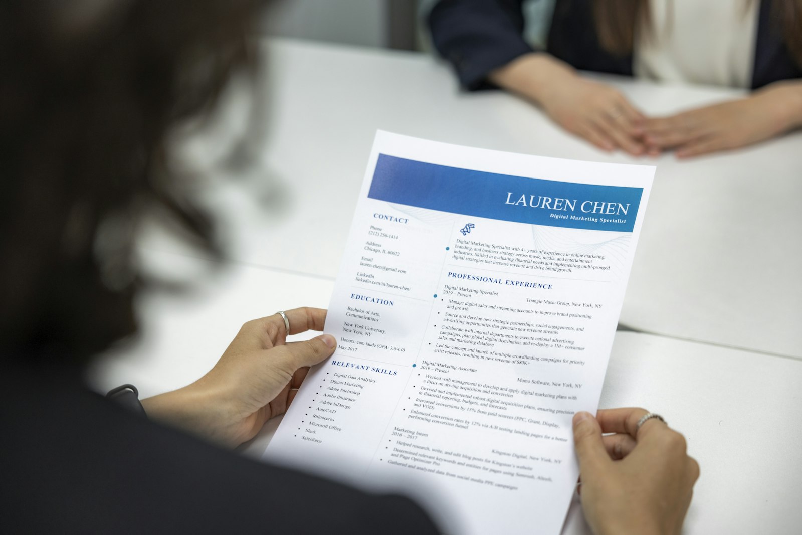 Resume reviewed on a laptop with notes nearby