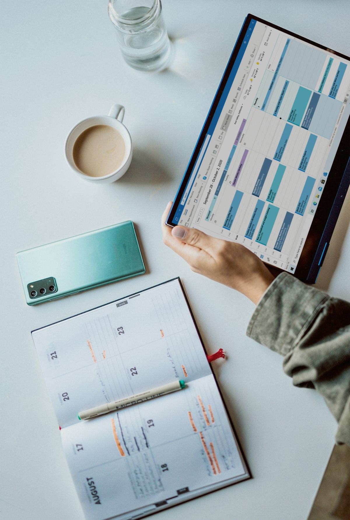 Calendar planner and notebook on a desk for time-blocking