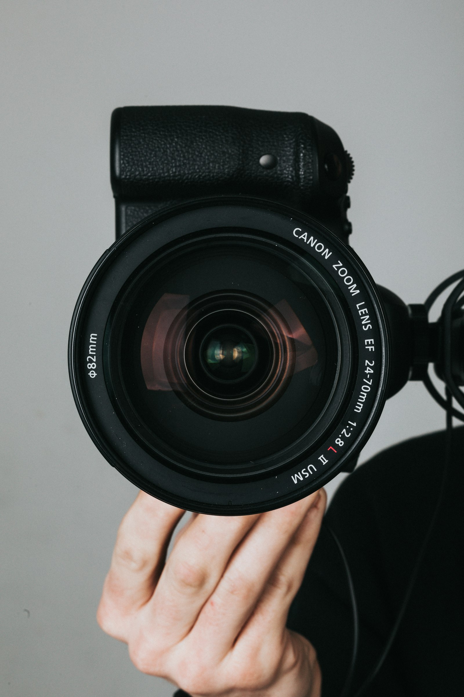 Content creator recording video at a desk setup with ring light, microphone, and camera on tripod
