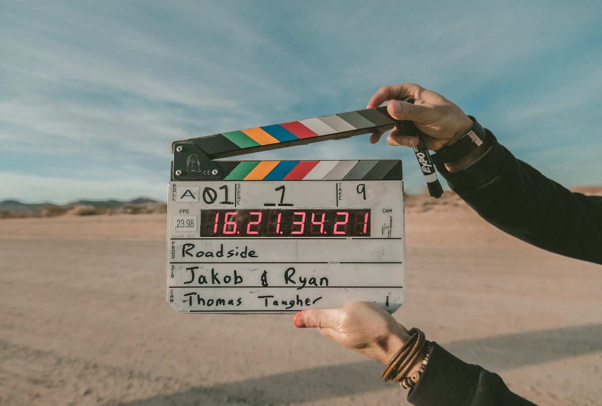 Close-up of camera lens and cinema lighting representing AI-assisted video production