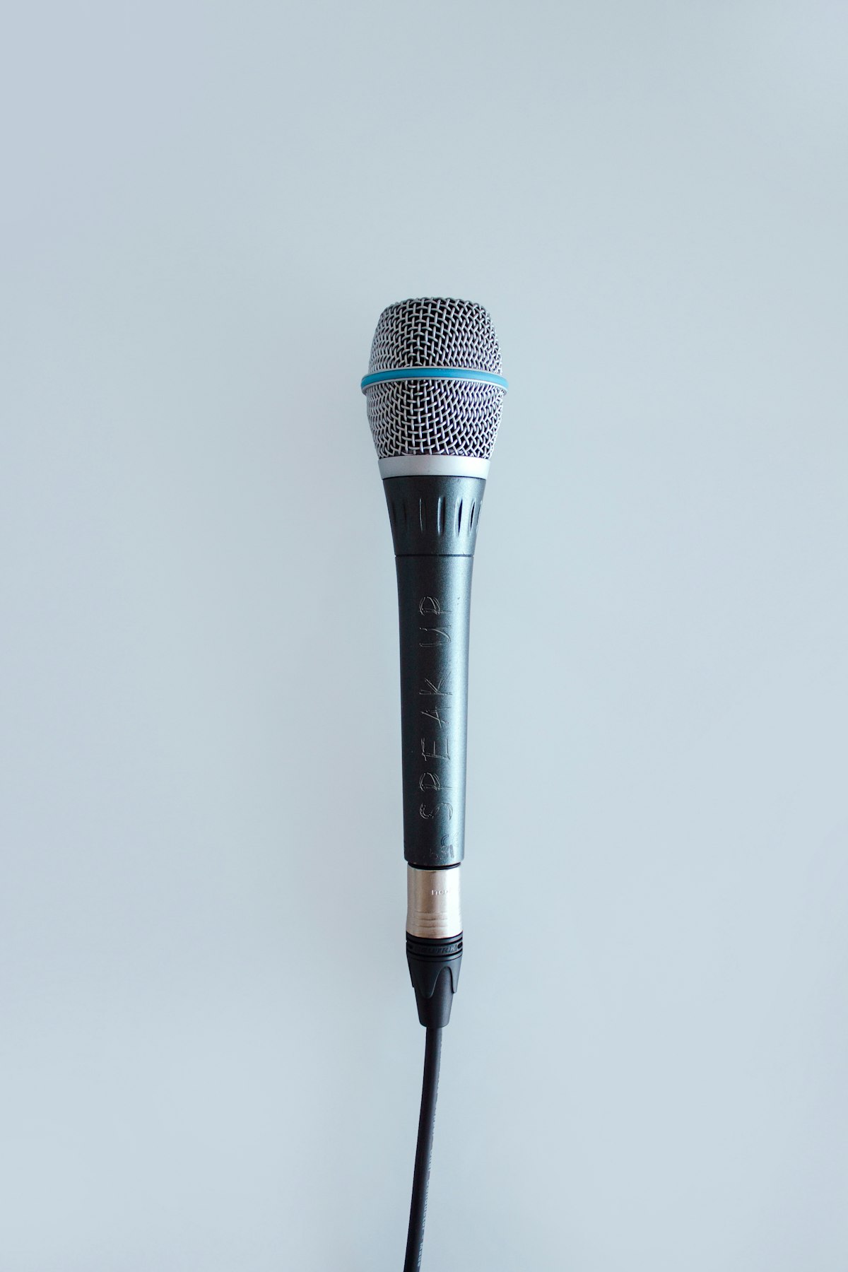 Headphones and microphone on a desk used by a voice creator for podcast and AI voice testing