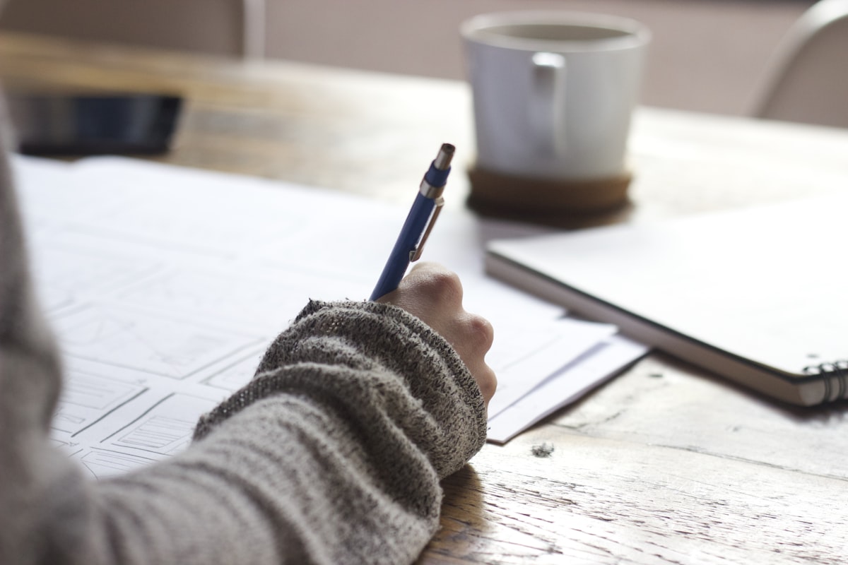 Notebook and pen on a writing desk