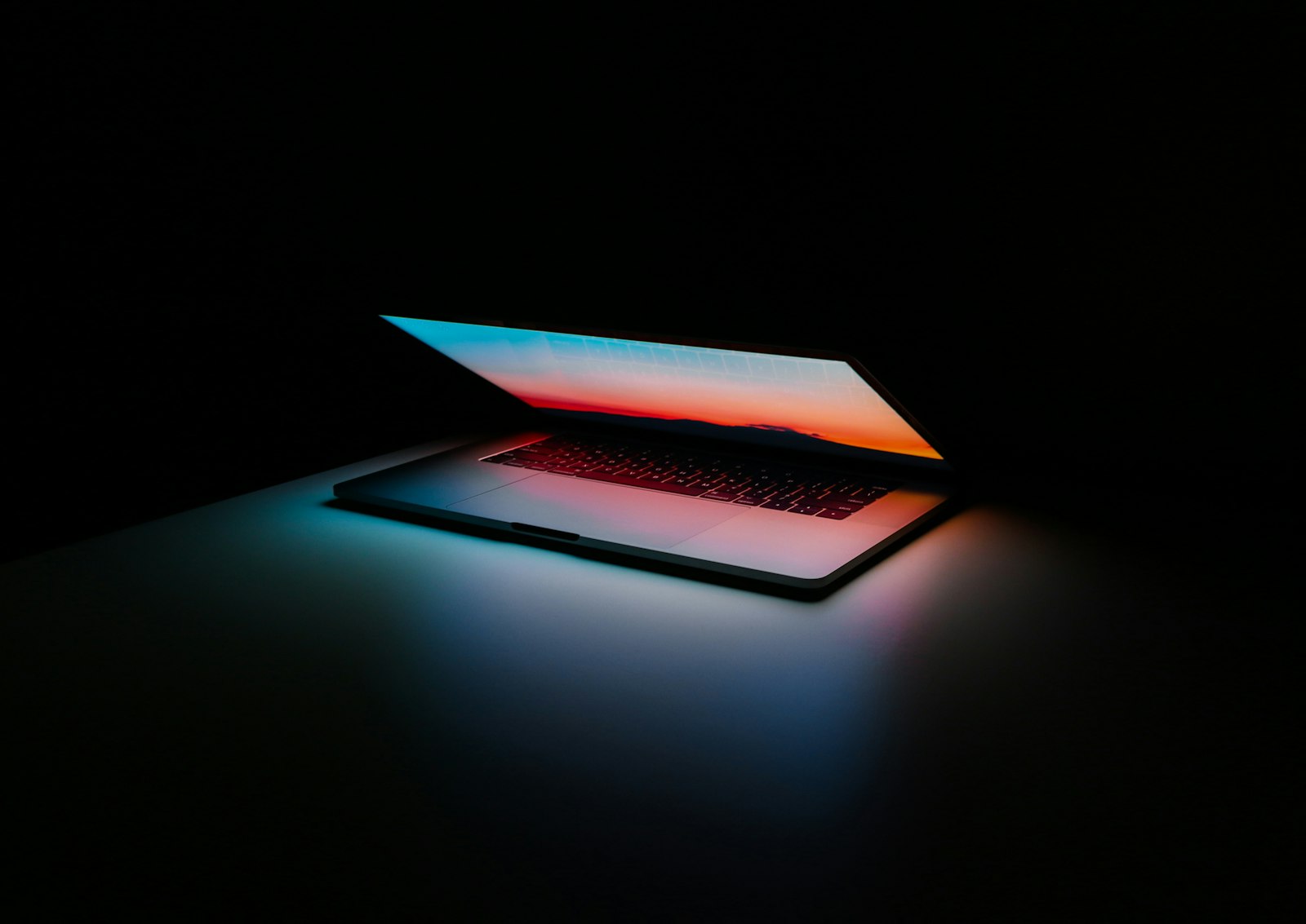 Laptop with a glowing screen in a modern workspace