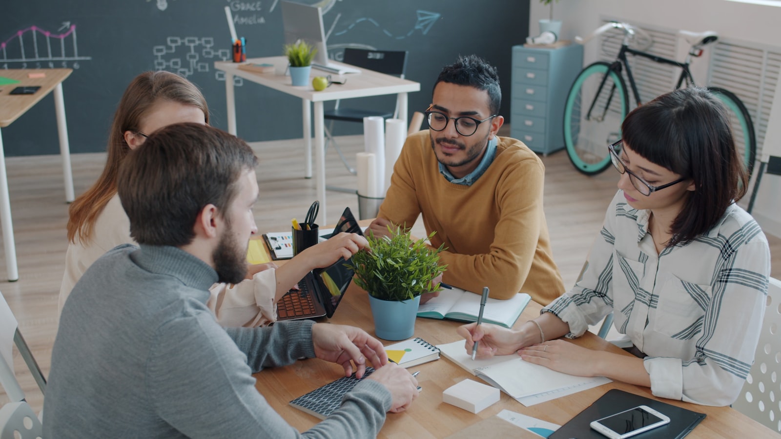 Diverse team of coworkers collaborating around a table in a modern office